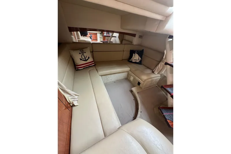 Slide: The Image of 2007 Sea Ray 320 Sundancer cabin with beige seating and nautical-themed pillows. - 27