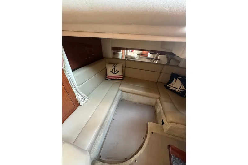 Slide: The Image of Interior of 2007 Sea Ray 320 Sundancer with beige seating and nautical-themed pillows. - 28