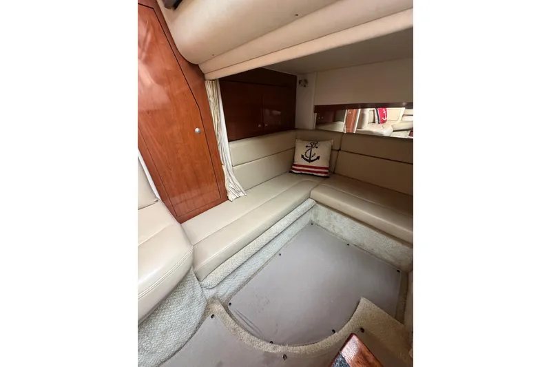 Slide: The Image of 2007 Sea Ray 320 Sundancer cabin interior with beige seating and nautical-themed decor. - 29