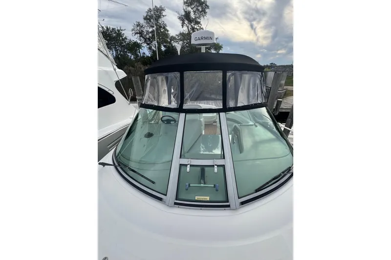 Slide: The Image of 2007 Sea Ray 320 Sundancer boat with Garmin equipment, docked under a cloudy sky. - 3