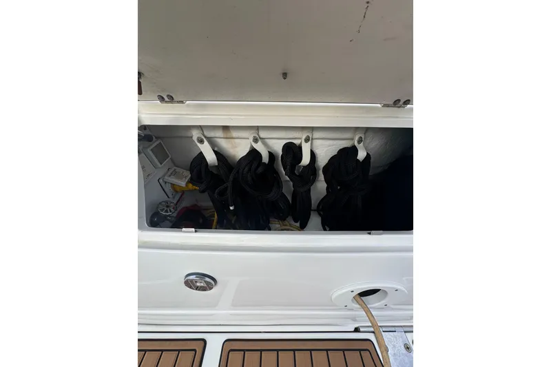 Slide: The Image of Storage compartment on a 2007 Sea Ray 320 Sundancer boat with coiled ropes. - 34