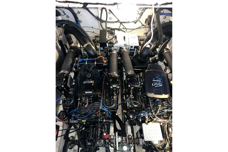 Slide: The Image of Engine compartment of a 2007 Sea Ray 320 Sundancer boat, showcasing dual engines. - 38