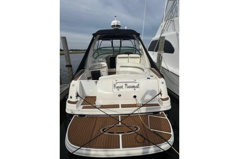 Slide: The Image of 2007 Sea Ray 320 Sundancer docked, featuring spacious deck and sleek design. - 6