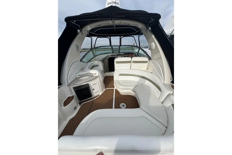 Slide: The Image of 2007 Sea Ray 320 Sundancer interior with white seating and wood flooring. - 7