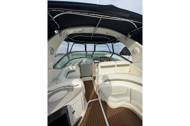 Slide: The Image of 2007 Sea Ray 320 Sundancer interior with elegant seating and helm, featuring wood flooring. - 9