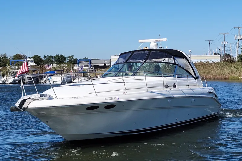 The Image of 2002 Sea Ray 410 Sundancer yacht cruising on a sunny day. - 0