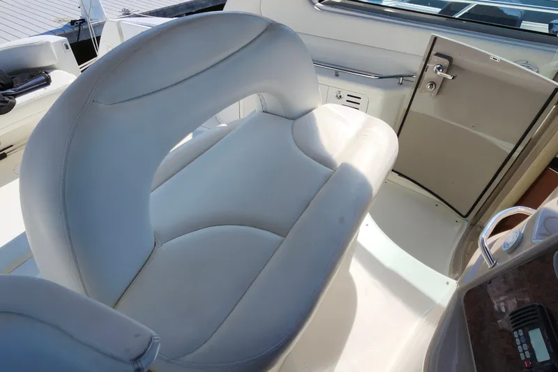 Slide: The Image of Luxurious seating on 2002 Sea Ray 410 Sundancer yacht, featuring sleek white upholstery. - 15