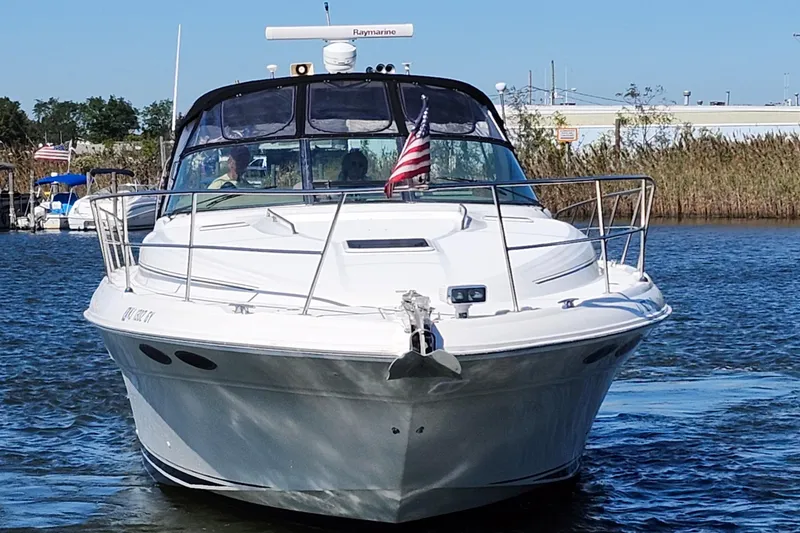 Slide: The Image of 2002 Sea Ray 410 Sundancer yacht cruising on a sunny day with American flag. - 2