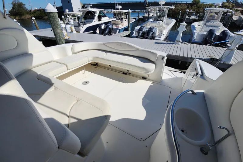 Slide: The Image of Luxurious 2002 Sea Ray 410 Sundancer yacht interior with spacious seating and docked boats in background. - 24