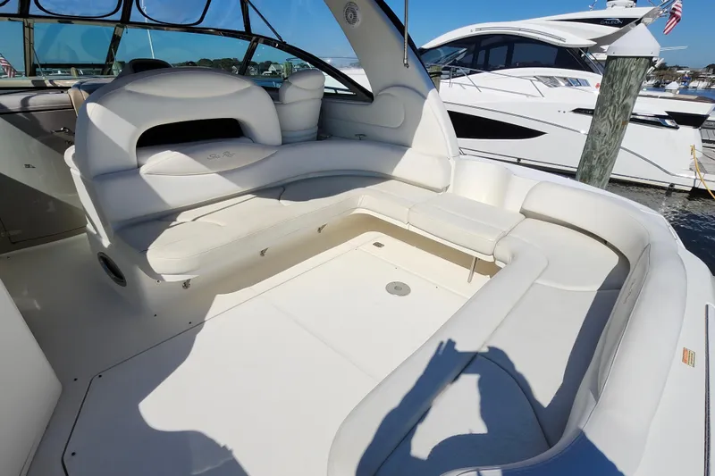 Slide: The Image of 2002 Sea Ray 410 Sundancer boat interior with white seating and open deck area. - 25