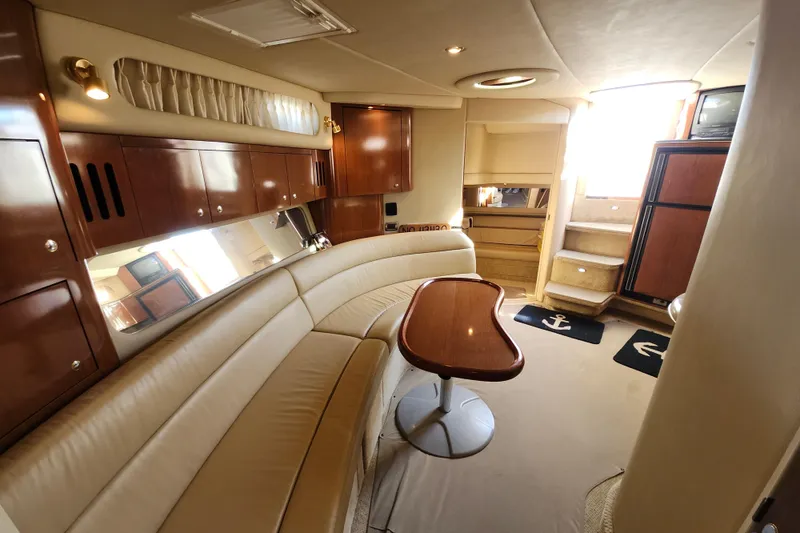 Slide: The Image of Luxurious interior of 2002 Sea Ray 410 Sundancer yacht with elegant seating and wooden finishes. - 29