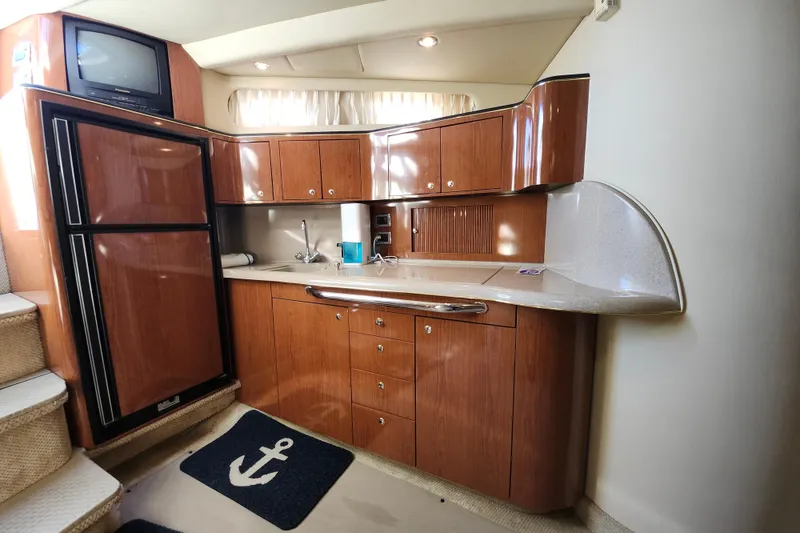 Slide: The Image of Luxurious kitchen area in a 2002 Sea Ray 410 Sundancer yacht with wood cabinetry. - 32
