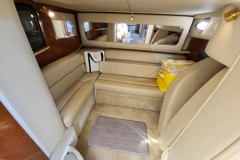 Slide: The Image of Interior of 2002 Sea Ray 410 Sundancer yacht with beige seating and mirror. - 33