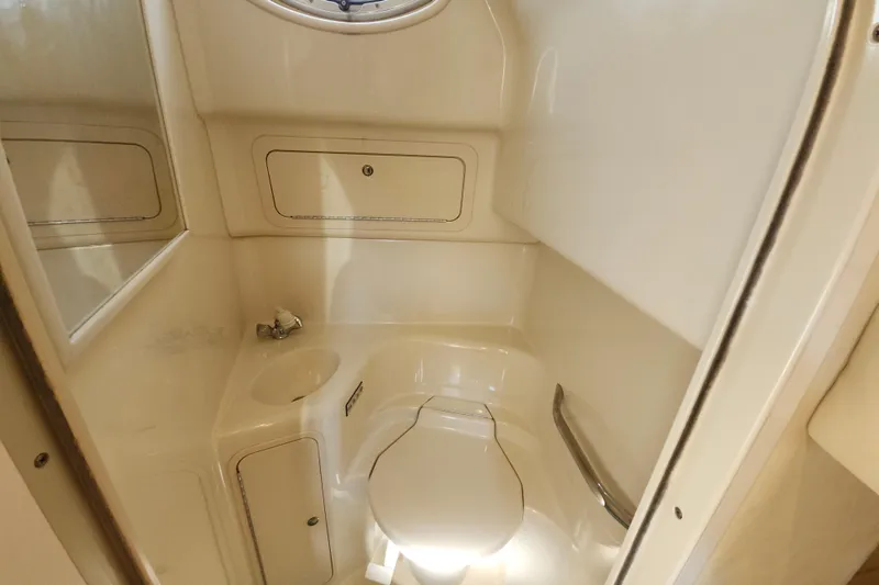 Slide: The Image of 2002 Sea Ray 410 Sundancer bathroom with compact design and built-in storage. - 38