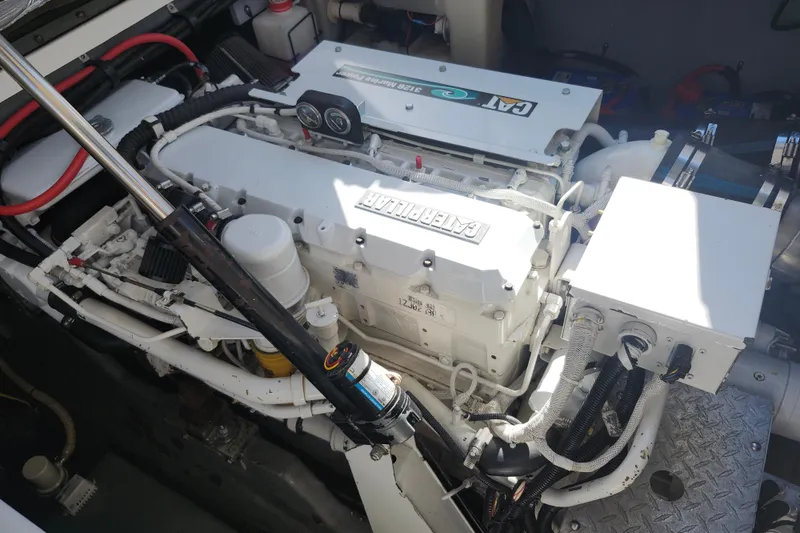 Slide: The Image of Engine compartment of a 2002 Sea Ray 410 Sundancer boat, featuring a Caterpillar engine. - 44