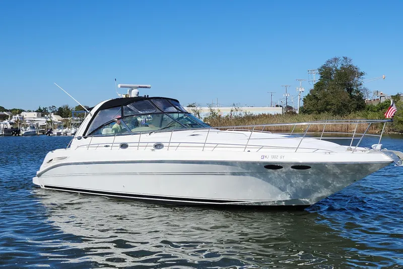 Slide: The Image of 2002 Sea Ray 410 Sundancer yacht cruising on a sunny day. - 7