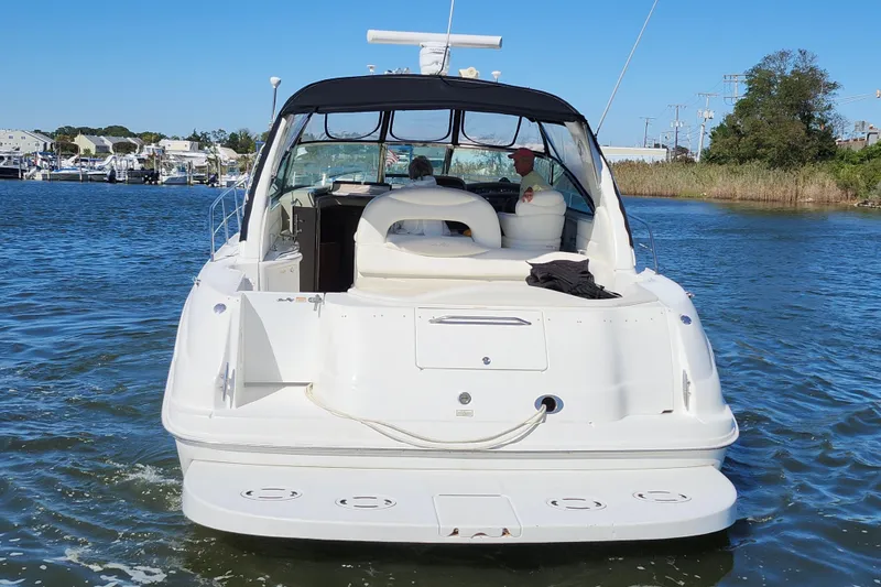 Slide: The Image of 2002 Sea Ray 410 Sundancer yacht cruising on a sunny day, rear view. - 8