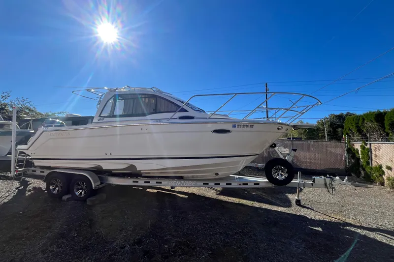 The Image of 2020 Cutwater C-24 Coupe boat on trailer under bright sunlit sky. - 1