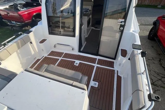 Slide: The Image of 2020 Cutwater C-24 Coupe boat interior with wood flooring and seating. - 11