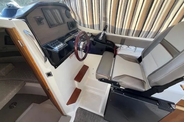 Slide: The Image of 2020 Cutwater C-24 Coupe interior with helm, steering wheel, and seating. - 17