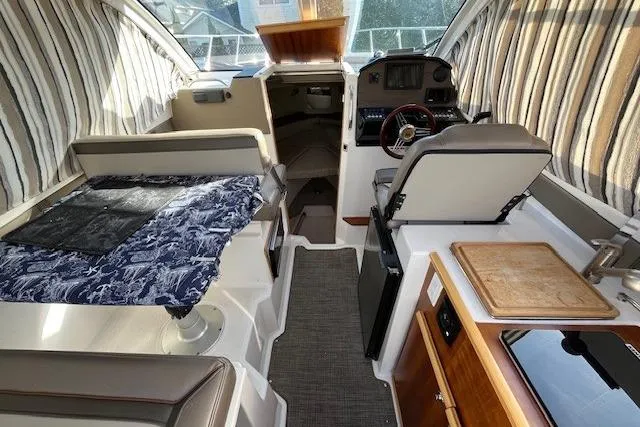 Slide: The Image of Interior of a 2020 Cutwater C-24 Coupe boat with seating and navigation area. - 18