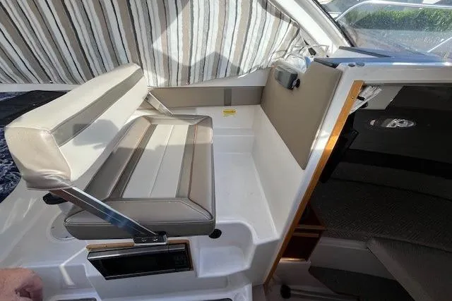 Slide: The Image of Interior seating of 2020 Cutwater C-24 Coupe boat with striped curtain backdrop. - 19