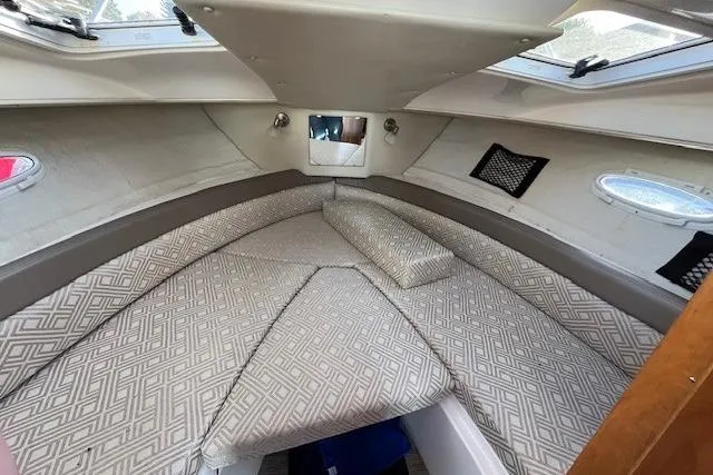 Slide: The Image of 2020 Cutwater C-24 Coupe cabin interior with patterned cushions and portholes. - 20