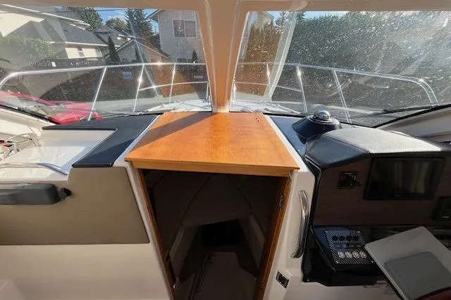 Slide: The Image of 2020 Cutwater C-24 Coupe interior with helm, dashboard, and cabin entrance. - 21