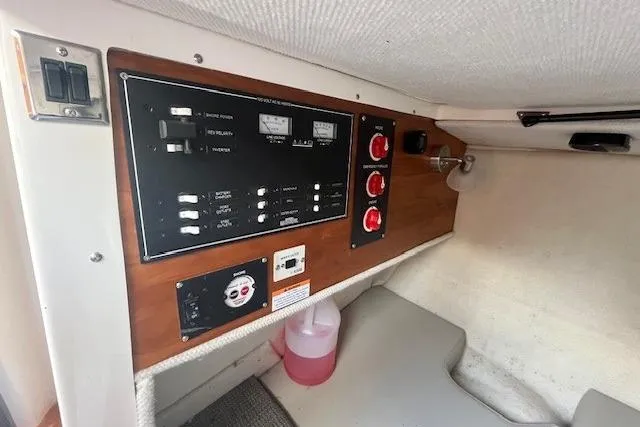 Slide: The Image of Control panel inside 2020 Cutwater C-24 Coupe boat cabin, featuring switches and gauges. - 31