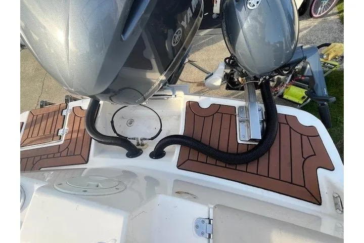 Slide: The Image of 2020 Cutwater C-24 Coupe boat with Yamaha outboard motors and teak-style deck. - 9