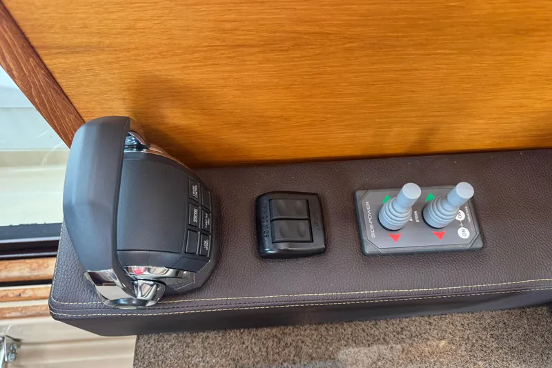 Slide: The Image of 2019 Ranger Tugs R-31 S control panel with throttle and joystick controls. - 15