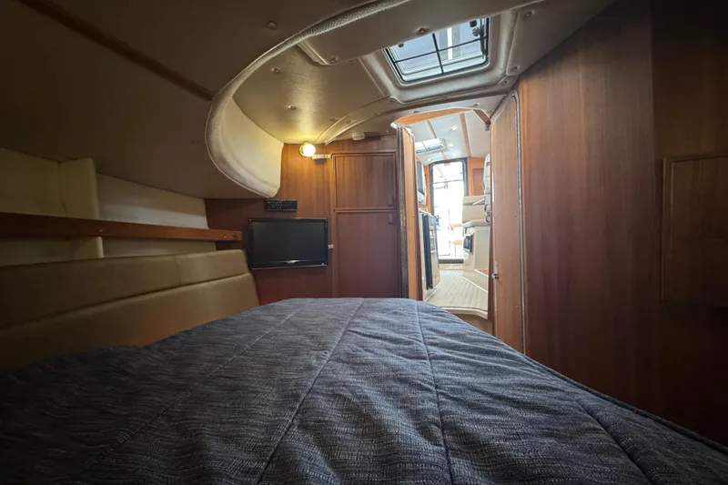 Slide: The Image of Interior cabin of 2019 Ranger Tugs R-31 S with cozy bed and wooden finish. - 17