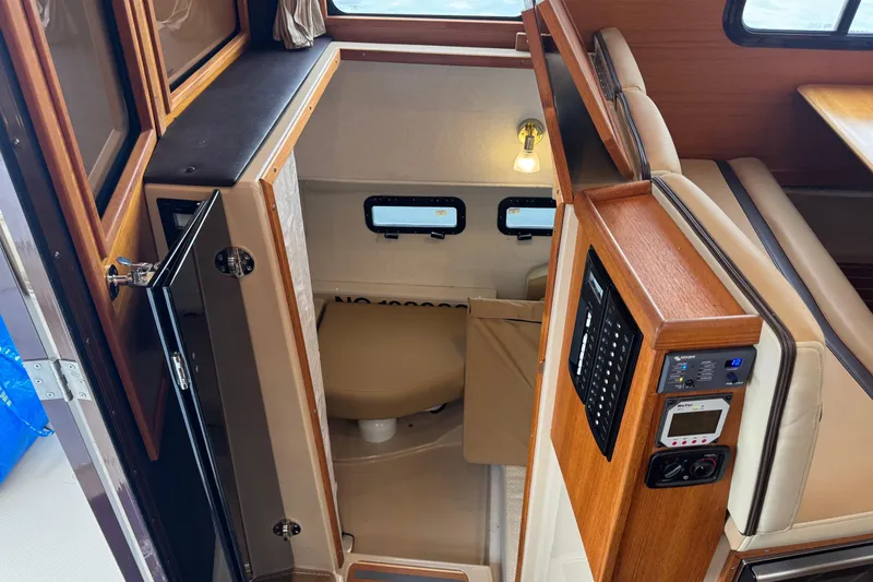 Slide: The Image of 2019 Ranger Tugs R-31 S interior cabin with wood accents and seating area. - 22