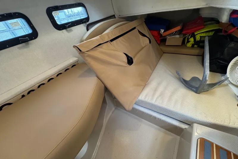 Slide: The Image of 2019 Ranger Tugs R-31 S cabin interior with seating, anchor, and storage items. - 23