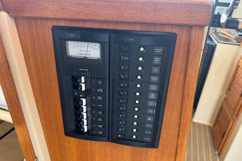 Slide: The Image of Electrical panel on 2019 Ranger Tugs R-31 S boat, featuring switches and voltage meter. - 24