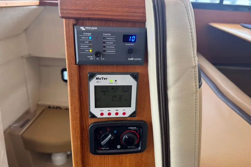 Slide: The Image of Control panel inside 2019 Ranger Tugs R-31 S boat, featuring Victron Energy charger and MeTer MT-1. - 25