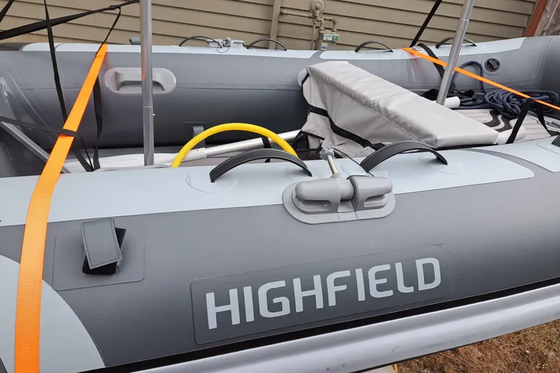 Slide: The Image of Highfield inflatable boat interior with orange straps and seating, 2019 Ranger Tugs R-31 S. - 30