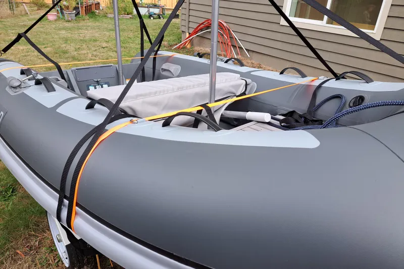 Slide: The Image of Inflatable boat secured with straps, near a house, associated with 2019 Ranger Tugs R-31 S. - 31