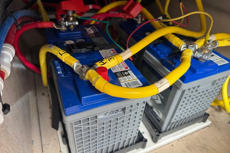 Slide: The Image of Batteries with yellow cables in a 2019 Ranger Tugs R-31 S boat. - 35