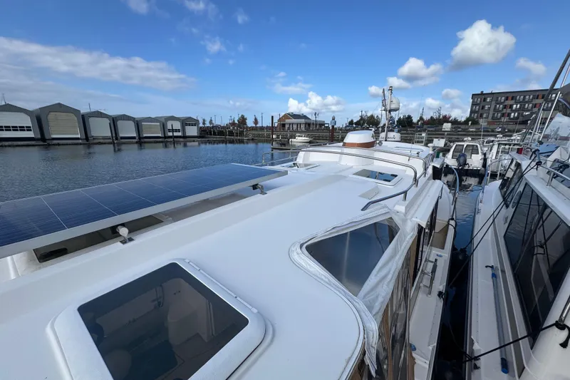 Slide: The Image of 2019 Ranger Tugs R-31 S docked with solar panels, marina view. - 38