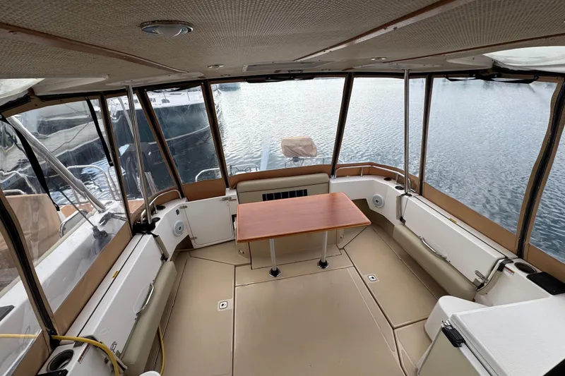 Slide: The Image of 2019 Ranger Tugs R-31 S interior with panoramic windows and central table. - 43