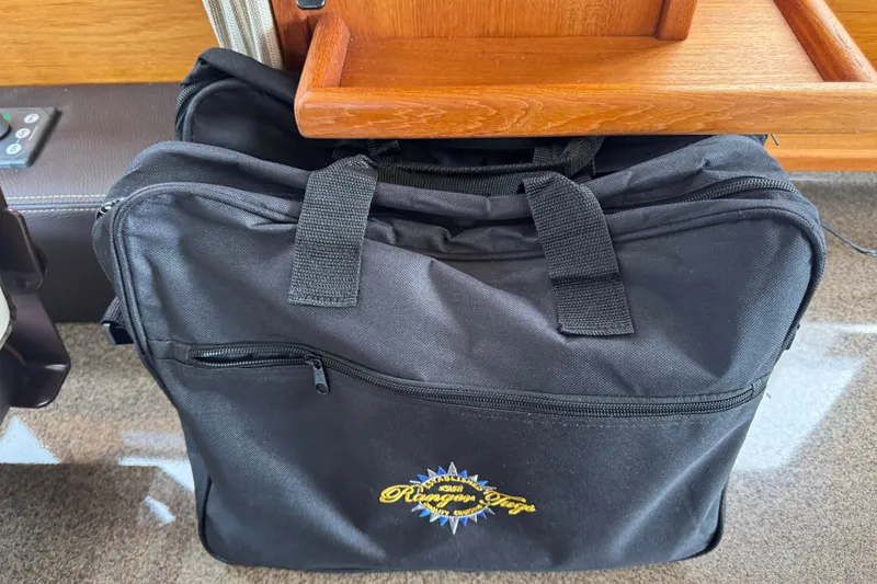 Slide: The Image of Black Ranger Tugs bag under wooden seat, 2019 R-31 S model. - 45