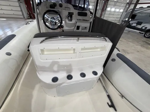 Slide: The Image of 2015 Brig Inflatables Eagle 780 boat interior with steering console and storage compartments. - 15