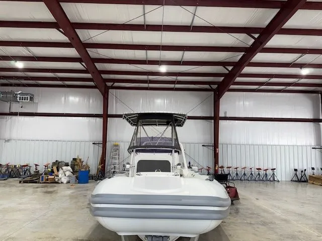 Slide: The Image of 2015 Brig Inflatables Eagle 780 boat in a spacious indoor storage facility. - 2