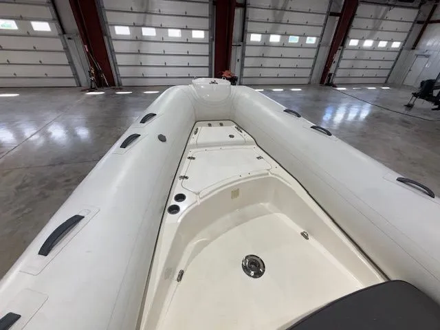 Slide: The Image of 2015 Brig Inflatables Eagle 780 boat interior in a spacious garage setting. - 6