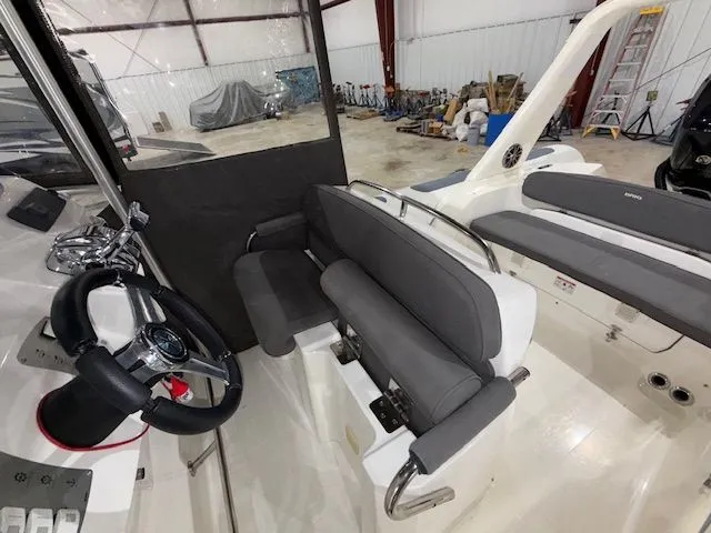 Slide: The Image of Interior of 2015 Brig Inflatables Eagle 780 boat with gray seating and steering wheel. - 9