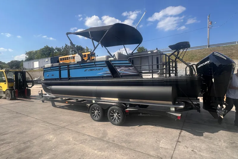 Slide: The Image of 2026 Starcraft CX 23 DL BAR pontoon boat on trailer, sunny day, outdoor setting. - 1