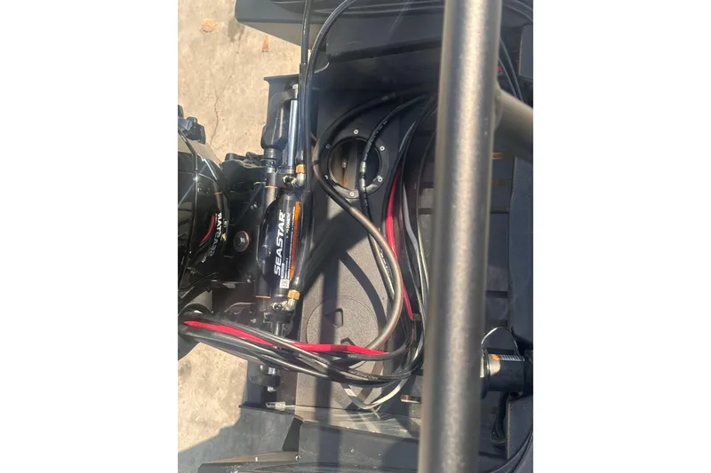 Slide: The Image of 2026 Starcraft CX 23 DL BAR boat engine components and wiring close-up. - 12