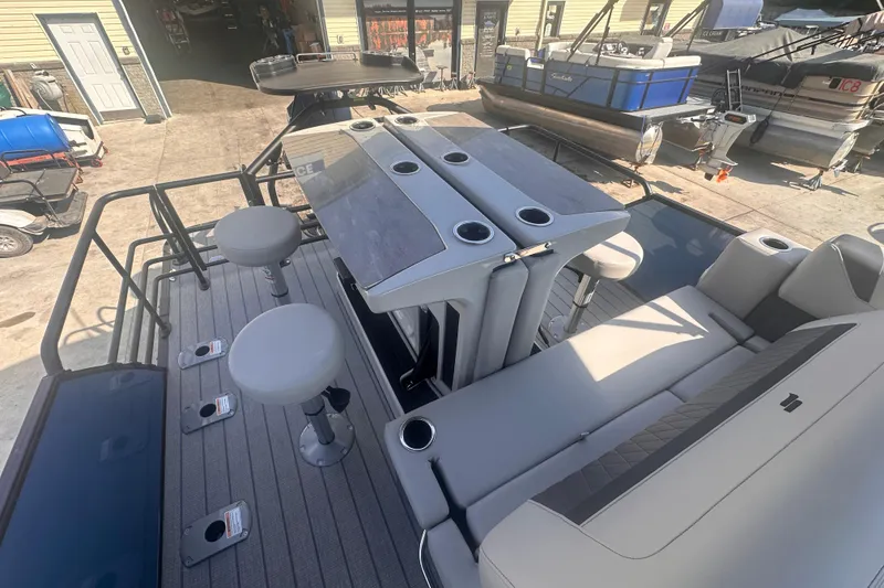 Slide: The Image of 2026 Starcraft CX 23 DL BAR pontoon boat with bar stools and seating area. - 2