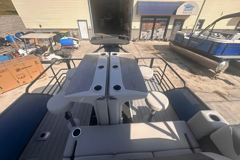 Slide: The Image of 2026 Starcraft CX 23 DL BAR pontoon boat at marina, featuring bar seating and modern design. - 3